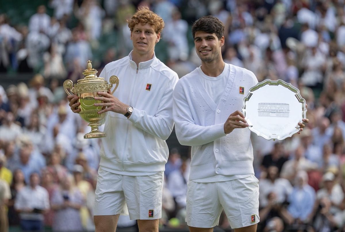 Jul 13, 2025; Wimbledon, United Kingdom; Carlos Alcaraz of Spain and Jannik Sinner of Italy pose with their trophies after the men’s singles final on day 14 at All England Lawn Tennis and Croquet Club. Mandatory Credit: Susan Mullane-Imagn Images