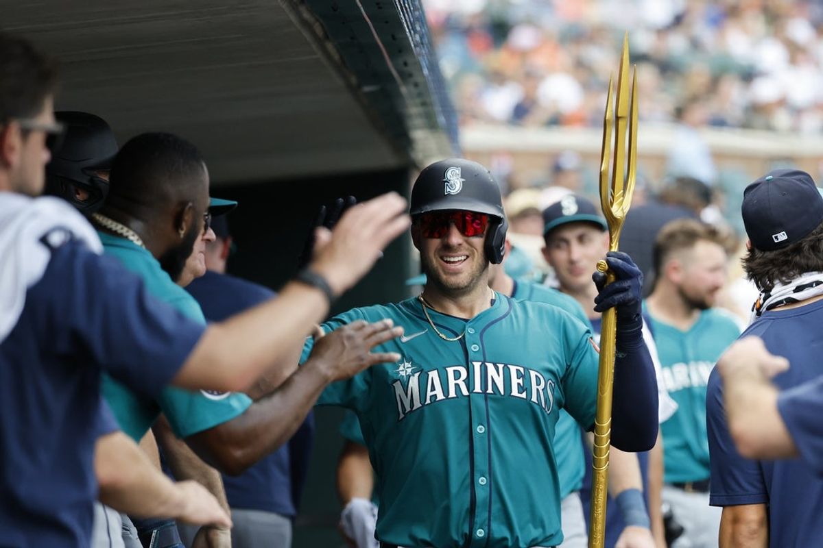 Jul 13, 2025; Detroit, Michigan, USA;  Seattle Mariners catcher Mitch Garver (18) receives congratulations from teammates after he hits a home run in the seventh inning against the Detroit Tigers at Comerica Park. Mandatory Credit: Rick Osentoski-Imagn Images