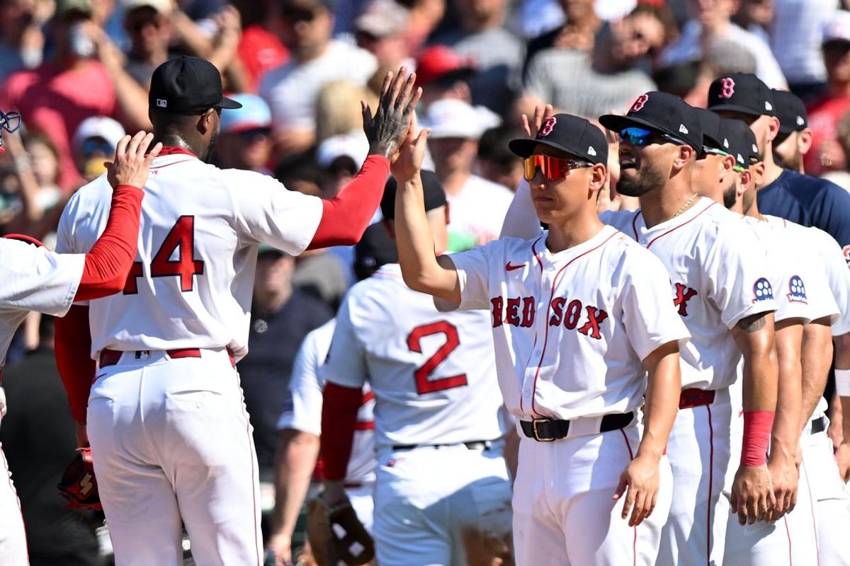 Jul 13, 2025; Boston, Massachusetts, USA; Boston Red Sox pitcher Aroldis Chapman (44) high-fives outfielder Masataka Yoshida (7) after a game against the Tampa Bay Rays during the ninth inning  at Fenway Park. Mandatory Credit: Brian Fluharty-Imagn Images