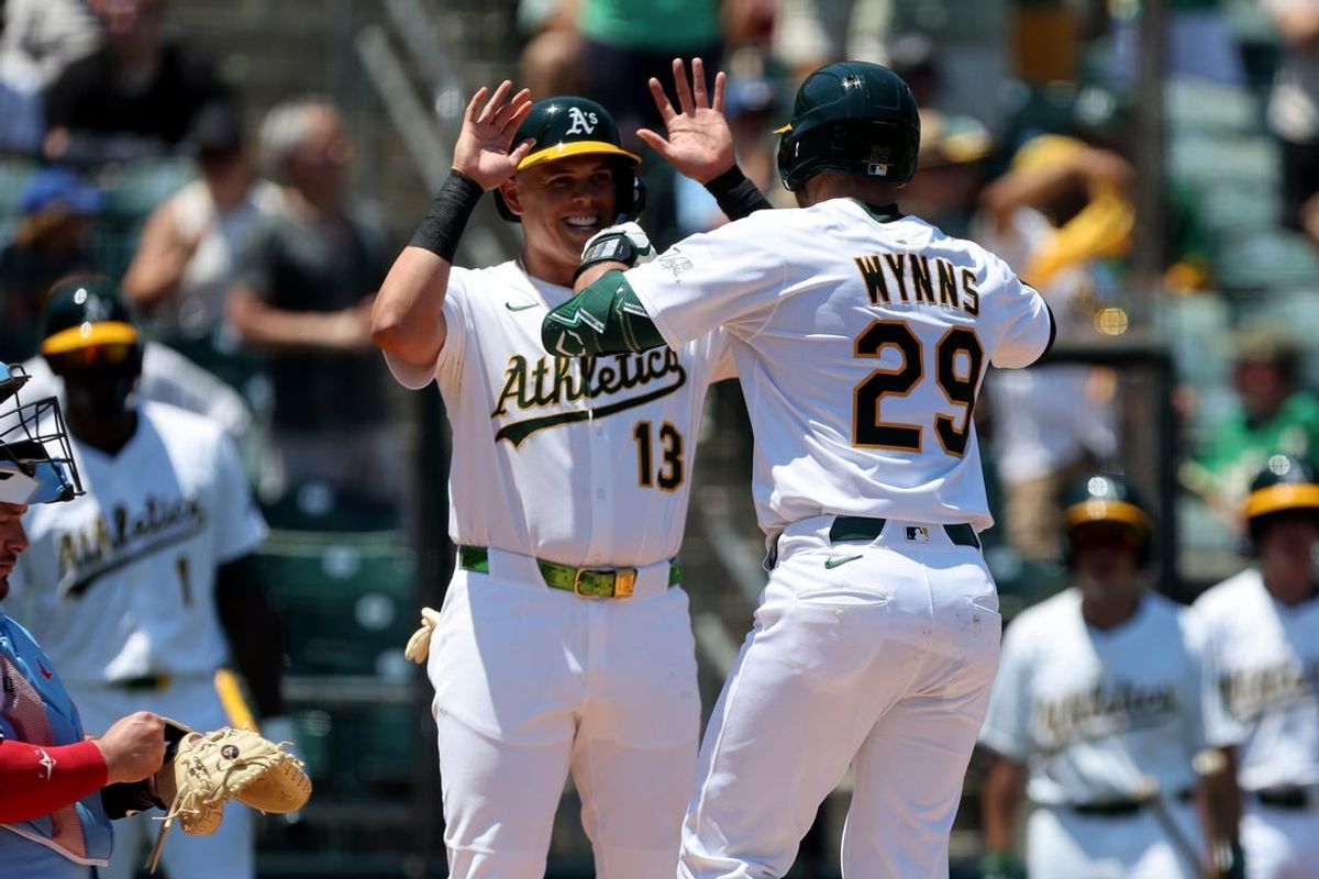 Jul 13, 2025; West Sacramento, California, USA; Athletics catcher Austin Wynns (29) is congratulated by third baseman Gio Urshela (13) after hitting a two-run home run against the Toronto Blue Jays during the second inning at Sutter Health Park. Mandatory Credit: Dennis Lee-Imagn Images