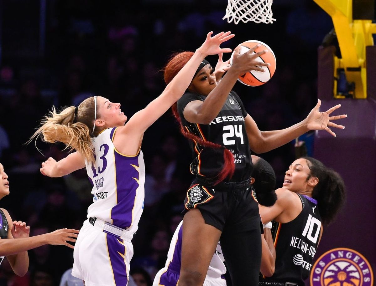 Jul 13, 2025; Los Angeles, California, USA; Los Angeles Sparks guard Sarah Ashlee Barker (13) and Connecticut Sun forward Aneesah Morrow (24) battle for a rebound during the second quarter at Crypto.com Arena. Mandatory Credit: Robert Hanashiro-Imagn Images