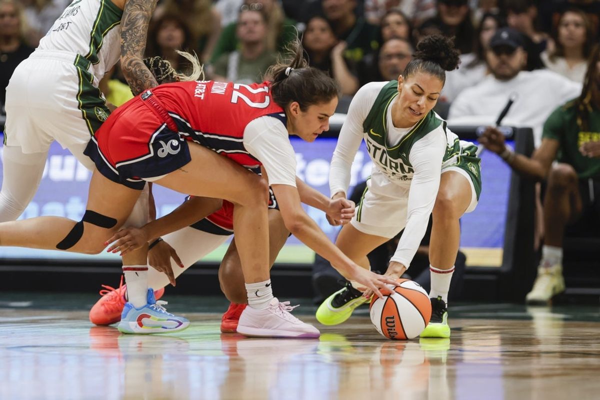 Jul 13, 2025; Seattle, Washington, USA; Washington Mystics guard Sonia Citron (22) and Seattle Storm forward Alysha Clark (32) reach for a loose ball during the second quarter at Climate Pledge Arena. Mandatory Credit: Joe Nicholson-Imagn Images