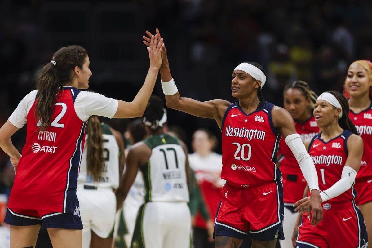 Jul 13, 2025; Seattle, Washington, USA; Washington Mystics guard Brittney Sykes (20) high-fives guard Sonia Citron (22) following a victory against the Seattle Storm at Climate Pledge Arena. Mandatory Credit: Joe Nicholson-Imagn Images