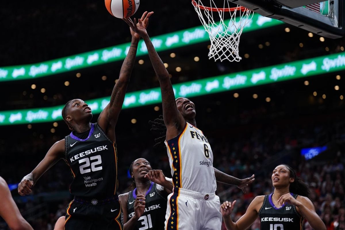 Jul 15, 2025; Boston, Massachusetts, USA;Indiana Fever forward Natasha Howard (6) and Connecticut Sun guard Saniya Rivers (22) work for the ball in the second quarter at TD Garden. Mandatory Credit: David Butler II-Imagn Images