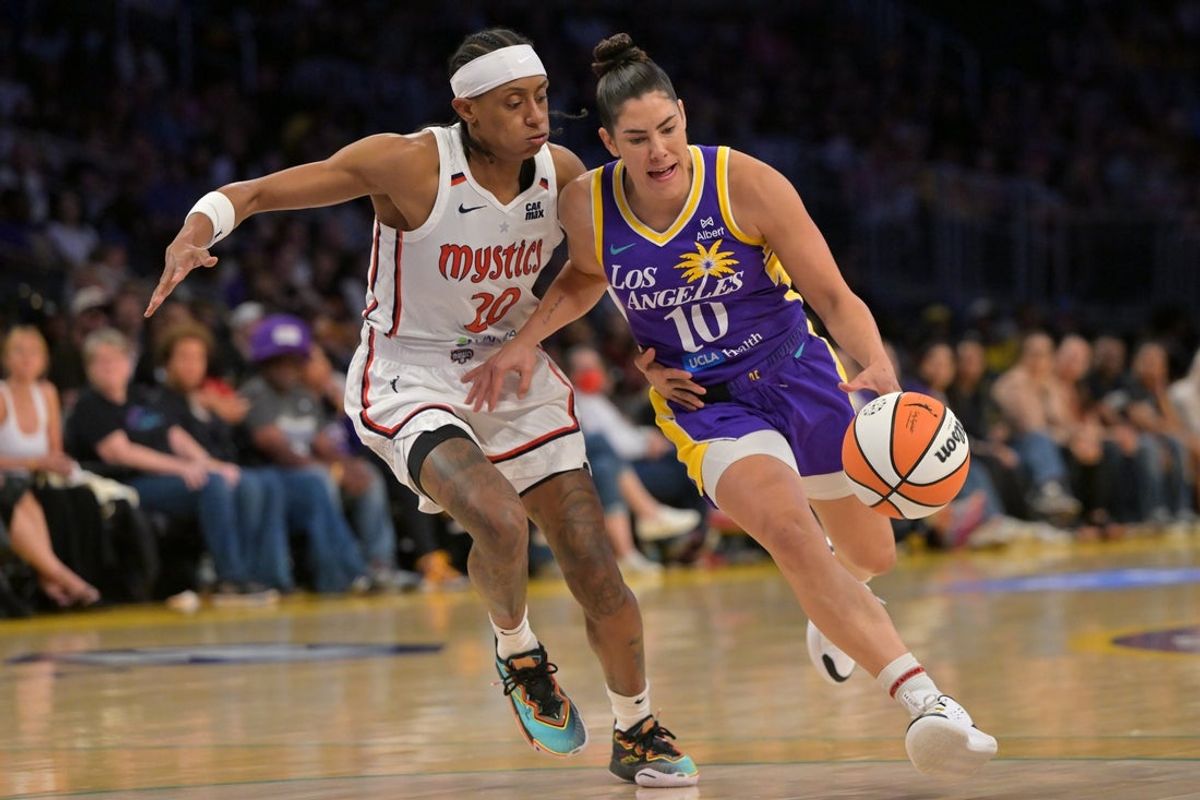 Jul 15, 2025; Los Angeles, California, USA; Los Angeles Sparks guard Kelsey Plum (10) is defended by Washington Mystics guard Brittney Sykes (20) during the first half at Crypto.com Arena. Mandatory Credit: Jayne Kamin-Oncea-Imagn Images