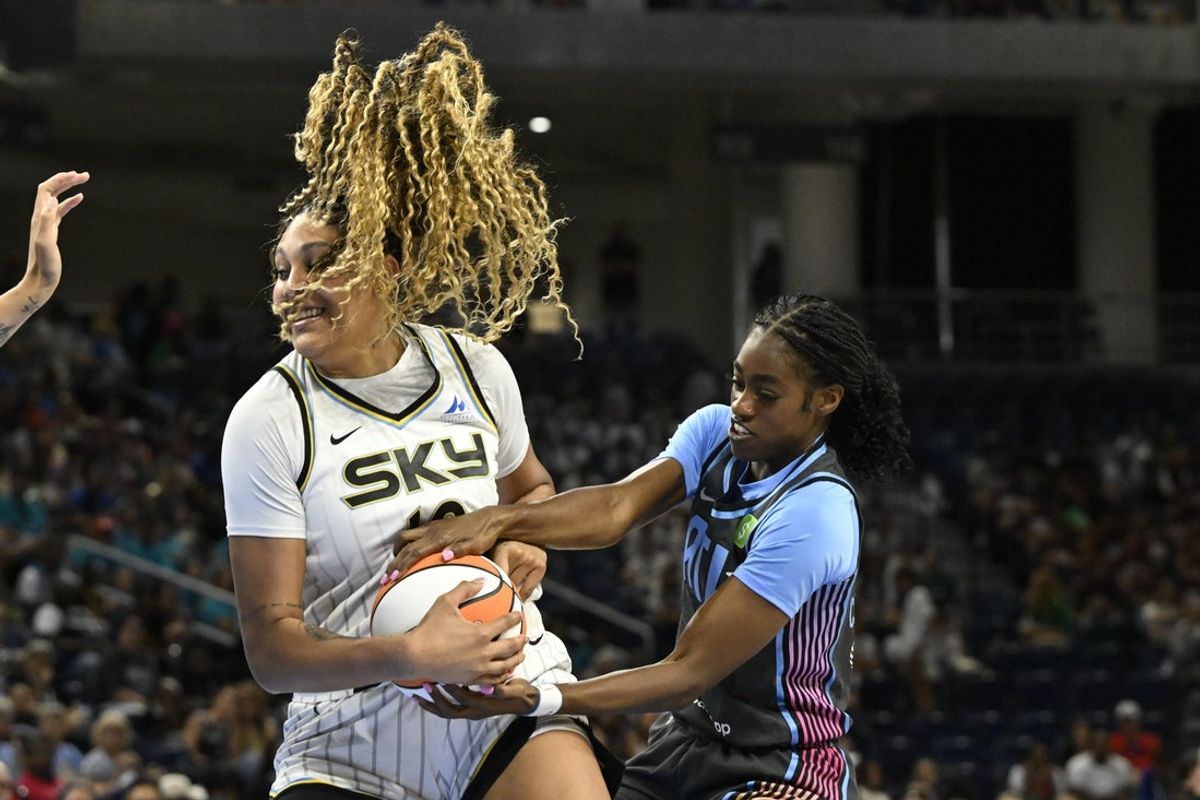 Jul 16, 2025; Chicago, Illinois, USA;  Chicago Sky center Kamilla Cardoso (10) fights for the ball against Atlanta Dream guard Maya Caldwell (33) during the first half at Wintrust Arena. Mandatory Credit: Matt Marton-Imagn Images
