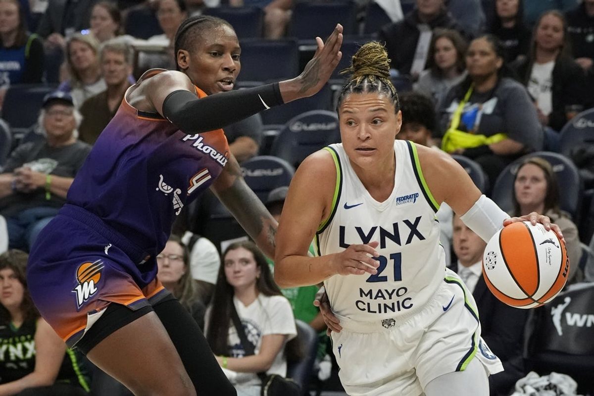 Jul 16, 2025; Minneapolis, Minnesota, USA; Minnesota Lynx guard Kayla McBride (2) works around Phoenix Mercury forward Natasha Mack (4) in the first quarter at Target Center. Mandatory Credit: Bruce Kluckhohn-Imagn Images