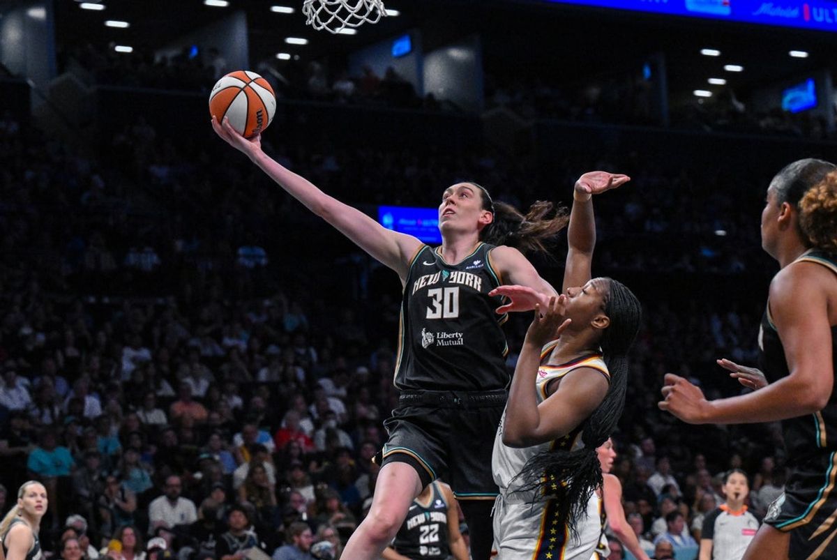 Jul 16, 2025; Brooklyn, New York, USA; New York Liberty forward Breanna Stewart (30) drives to the basket while defended by Indiana Fever forward Aliyah Boston (7) during the first half at Barclays Center. Mandatory Credit: John Jones-Imagn Images