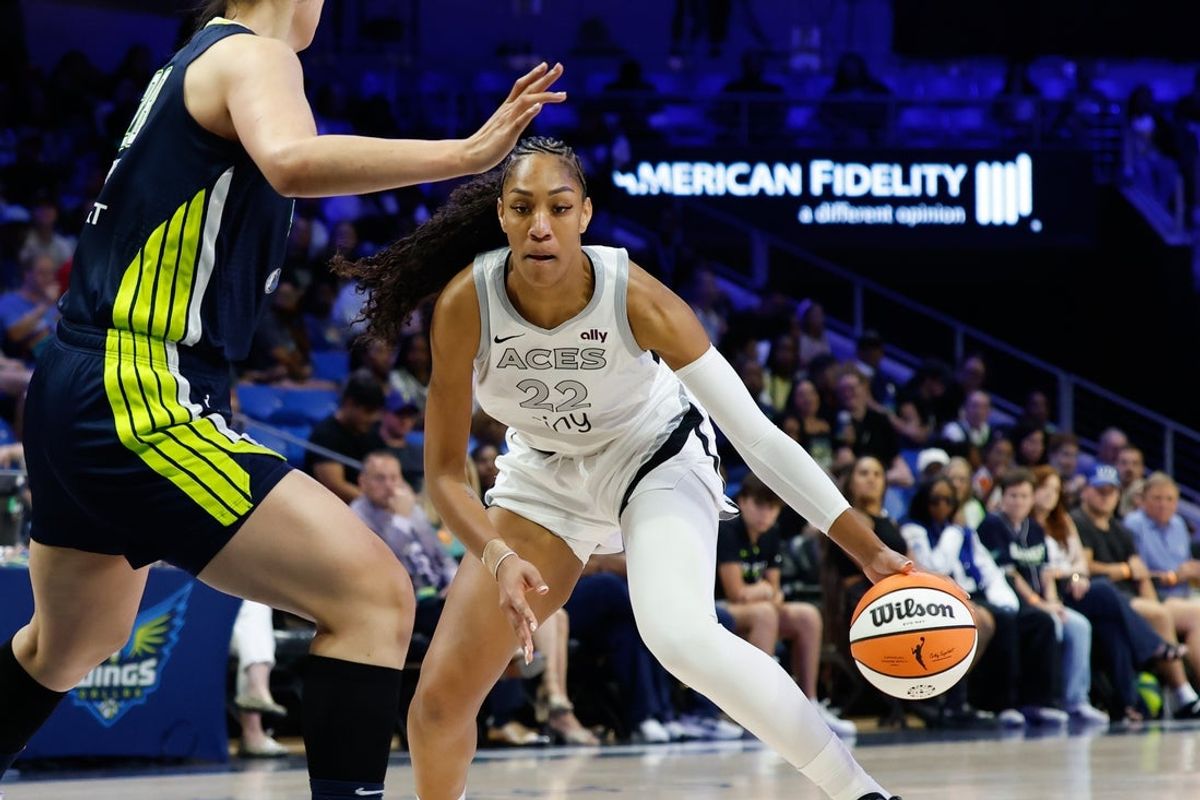 Jul 16, 2025; Arlington, Texas, USA; Las Vegas Aces center A'ja Wilson (22) drives to the basket against Dallas Wings center Li Yueru (28) during the first half at College Park Center. Mandatory Credit: Chris Jones-Imagn Images