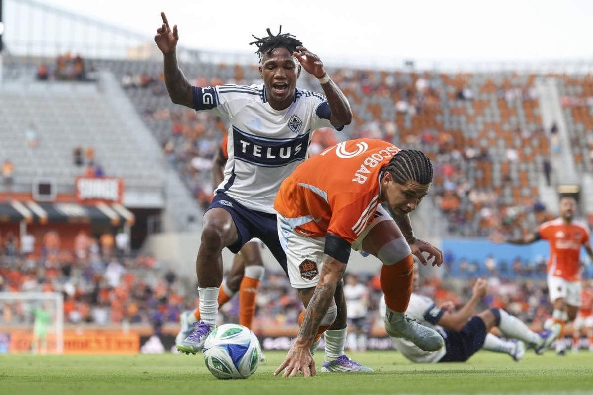 Jul 16, 2025; Houston, Texas, USA; Vancouver Whitecaps FC defender Edier Ocampo (18) and Houston Dynamo FC defender Franco Escobar (2) battle for the ball during the first half at Shell Energy Stadium. Mandatory Credit: Troy Taormina-Imagn Images