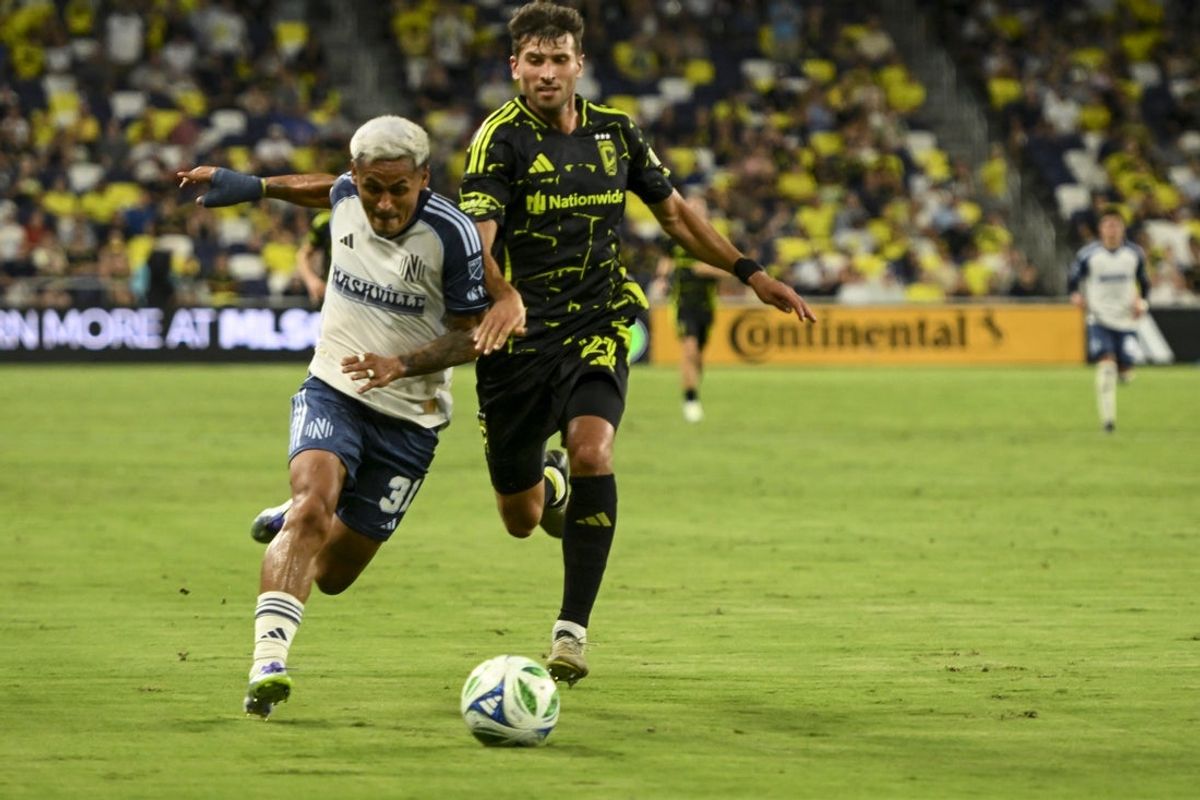 Jul 16, 2025; Nashville, Tennessee, USA;  Columbus Crew forward Max Arfsten (27) and Nashville SC midfielder Andy Najar (31) fights for the ball during the first period at Geodis Park. Mandatory Credit: Steve Roberts-Imagn Images