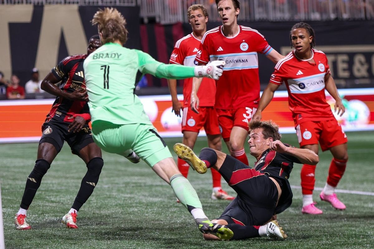 Jul 16, 2025; Atlanta, Georgia, USA; Atlanta United midfielder Will Reilly (28) scores a goal past Chicago Fire goalkeeper Chris Brady (1) in the second half at Mercedes-Benz Stadium. Mandatory Credit: Brett Davis-Imagn Images