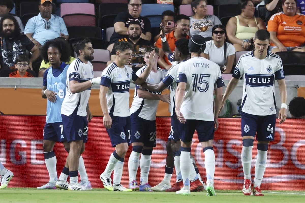Jul 16, 2025; Houston, Texas, USA; Vancouver Whitecaps FC forward Brian White (24) celebrates with teammates after scoring a goal during the second half against Houston Dynamo FC at Shell Energy Stadium. Mandatory Credit: Troy Taormina-Imagn Images