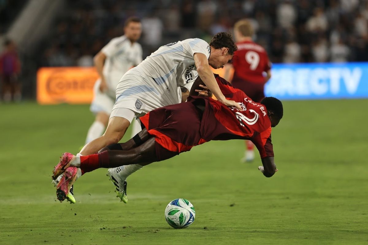 Jul 16, 2025; San Diego, California, USA; San Diego FC defender Oscar Verhoeven (33) and Toronto FC defender Richie Laryea (22) battle over the ball in the first half at Snapdragon Stadium. Mandatory Credit: Julia Kapros-Imagn Images