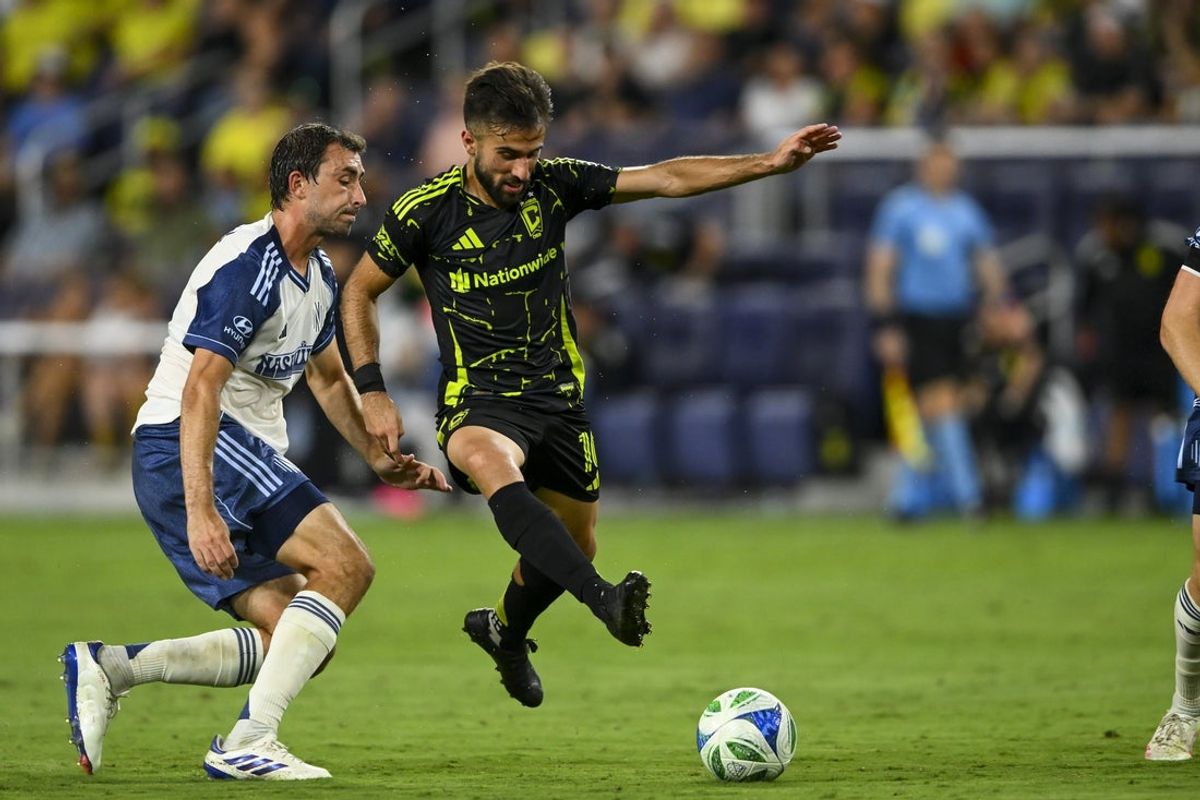 Jul 16, 2025; Nashville, Tennessee, USA;  Nashville SC midfielder Alex Muyl (19) pokes the ball from Columbus Crew forward Diego Rossi (10) during the second period at Geodis Park. Mandatory Credit: Steve Roberts-Imagn Images