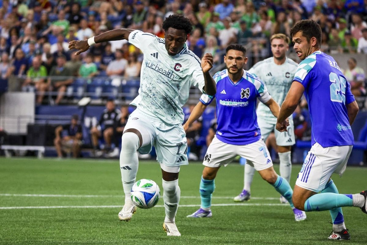 Jul 16, 2025; Seattle, Washington, USA; Colorado Rapids forward Darren Yapi (77) scores a goal against Seattle Sounders FC defender Jackson Ragen (25) during the second half at Lumen Field. Mandatory Credit: Joe Nicholson-Imagn Images
