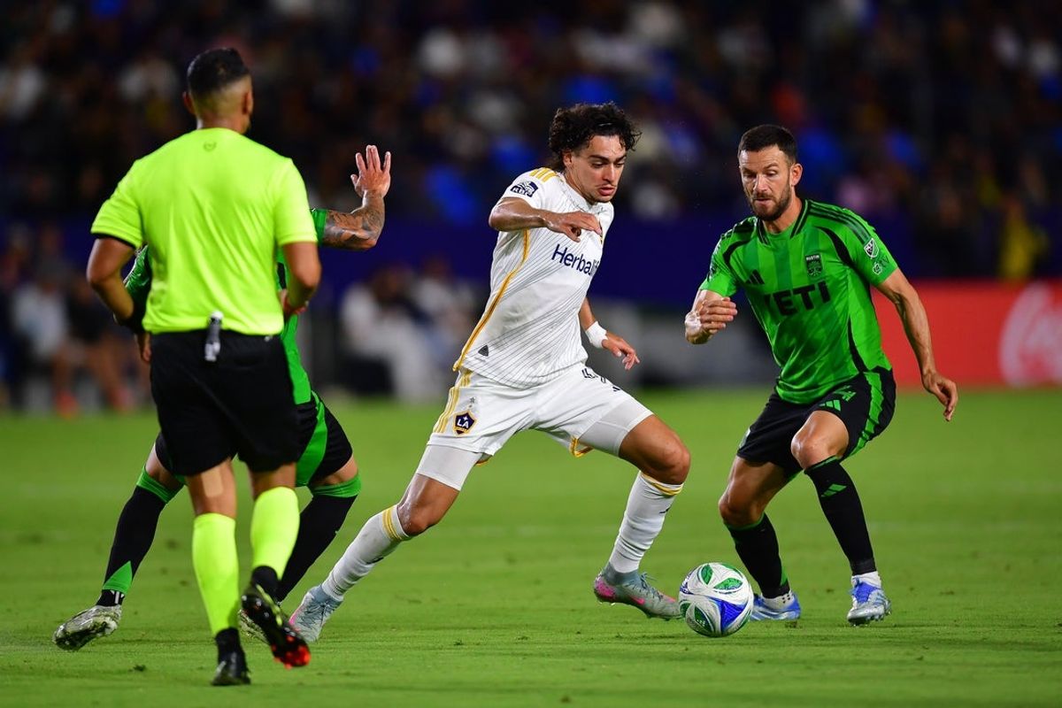 Jul 16, 2025; Carson, California, USA; LA Galaxy forward Matheus Nascimento (9) moves the ball against Austin FC midfielder Besard Sabovic (14) during the second half at Dignity Health Sports Park. Mandatory Credit: Gary A. Vasquez-Imagn Images