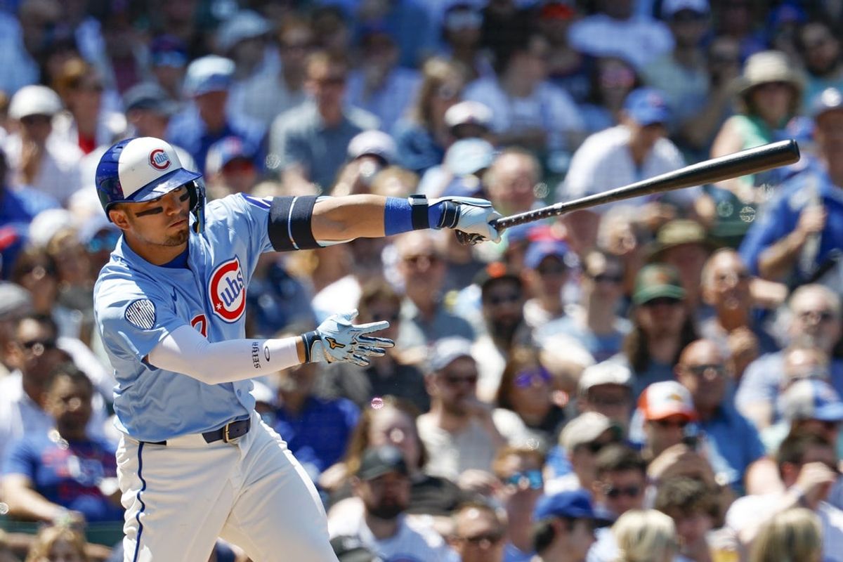 Jul 18, 2025; Chicago, Illinois, USA; Chicago Cubs designated hitter Seiya Suzuki (27) hits a single against the Boston Red Sox during the third inning at Wrigley Field. Mandatory Credit: Kamil Krzaczynski-Imagn Images