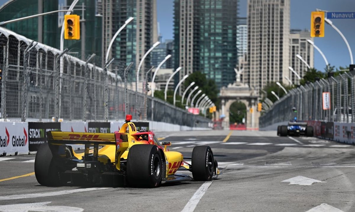 Jul 18, 2025; Toronto, Ontario, Canada;  Indycar driver Alex Palou (10) turns towards the Princes Gates during first practice for the Ontario Honda Dealers Indycar race. Mandatory Credit: Dan Hamilton-Imagn Images