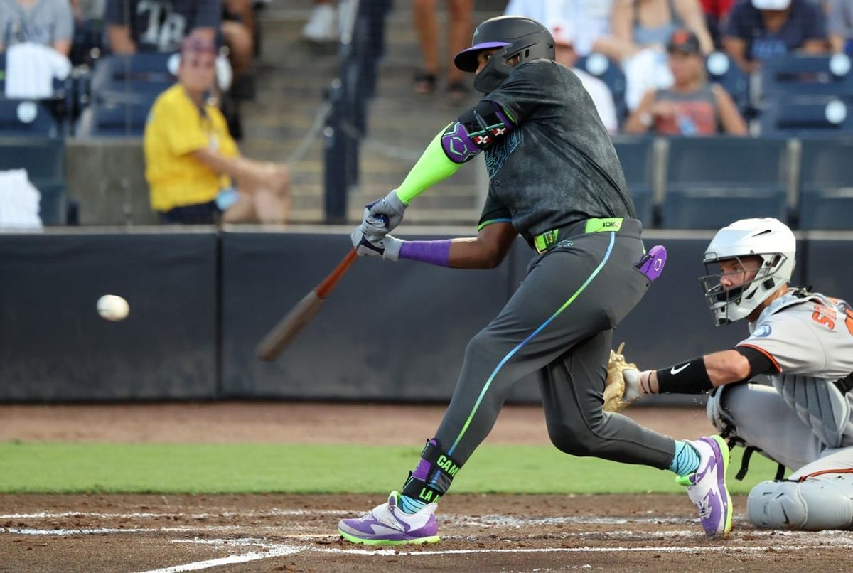 Jul 21, 2025; St. Petersburg, Florida, USA;  Tampa Bay Rays third base Junior Caminero (13) singles during the third inning against the Baltimore Orioles at George M. Steinbrenner Field. Mandatory Credit: Kim Klement Neitzel-Imagn Images