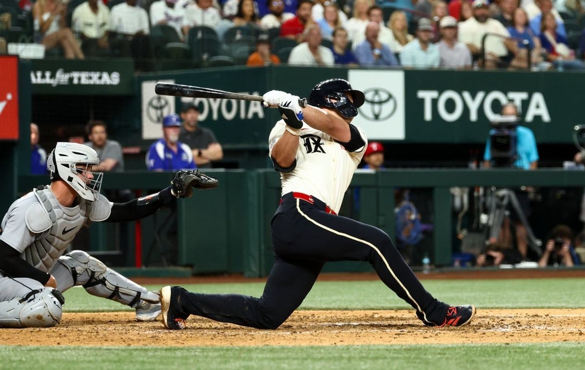 Jul 18, 2025; Arlington, Texas, USA;  Texas Rangers shortstop Corey Seager (5) hits a two-run double during the eighth inning against the Detroit Tigers at Globe Life Field. Mandatory Credit: Kevin Jairaj-Imagn Images