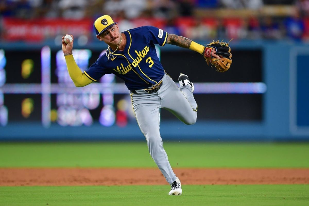 Jul 18, 2025; Los Angeles, California, USA; Milwaukee Brewers shortstop Joey Ortiz (3) throws to first for the out against Los Angeles Dodgers shortstop Mookie Betts (50) during the ninth inning at Dodger Stadium. Mandatory Credit: Gary A. Vasquez-Imagn Images