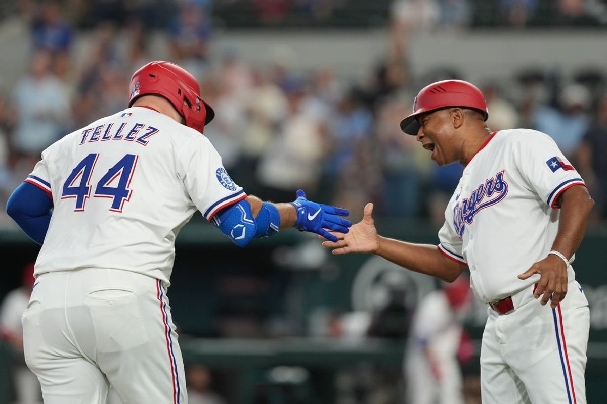 Jul 19, 2025; Arlington, Texas, USA;  Texas Rangers first baseman Rowdy Tellez (44) celebrates his three-run home run with third base coach Tony Beasley (27) against the Detroit Tigers during the second inning at Globe Life Field. Mandatory Credit: Jim Cowsert-Imagn Images