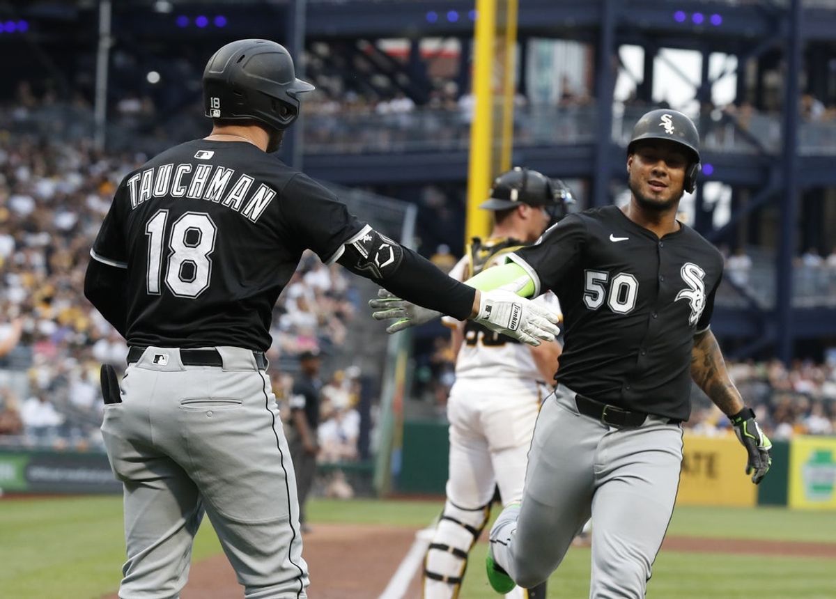 Jul 19, 2025; Pittsburgh, Pennsylvania, USA;  Chicago White Sox right fielder Mike Tauchman (18) greets designated hitter Lenyn Sosa (50) crossing home plate to score a run against the Pittsburgh Pirates during the fifth inning at PNC Park. Mandatory Credit: Charles LeClaire-Imagn Images
