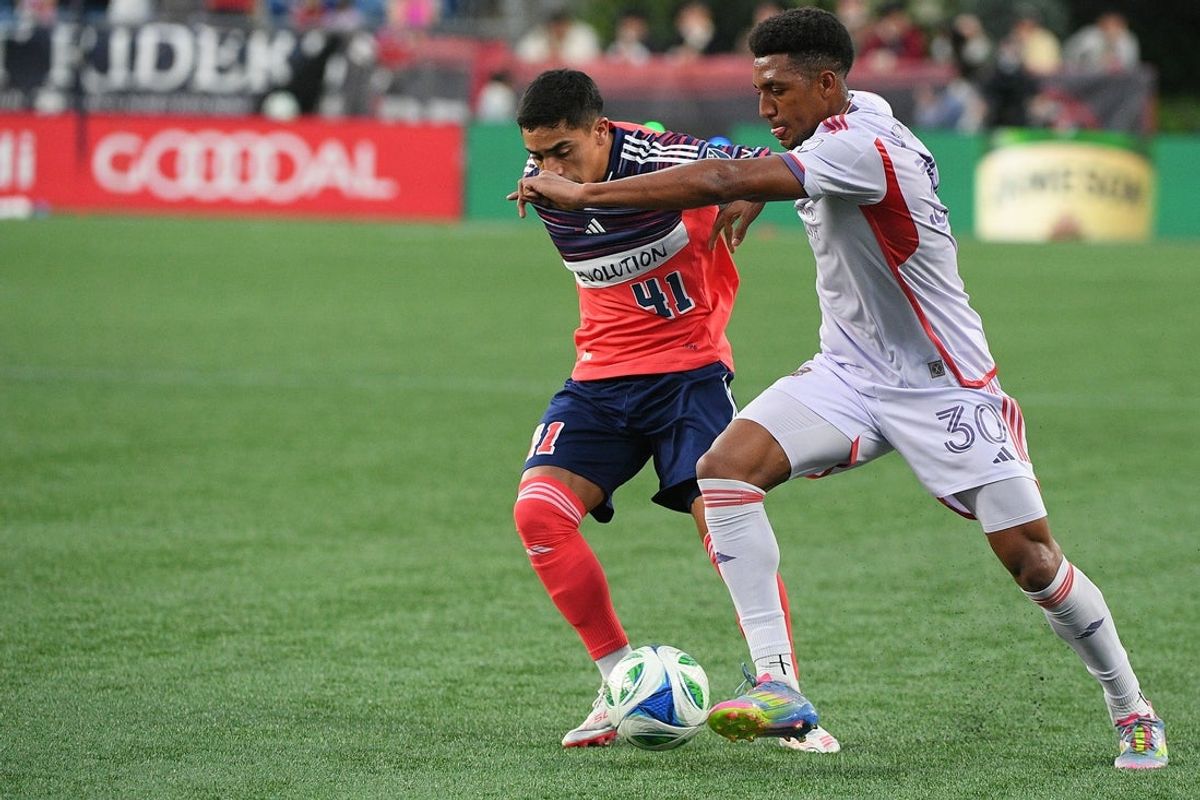 Jul 19, 2025; Foxborough, Massachusetts, USA; New England Revolution forward Luca Langoni (41) and Orlando City defender Alex Freeman (30) battle for the ball during the first half at Gillette Stadium. Mandatory Credit: Bob DeChiara-Imagn Images