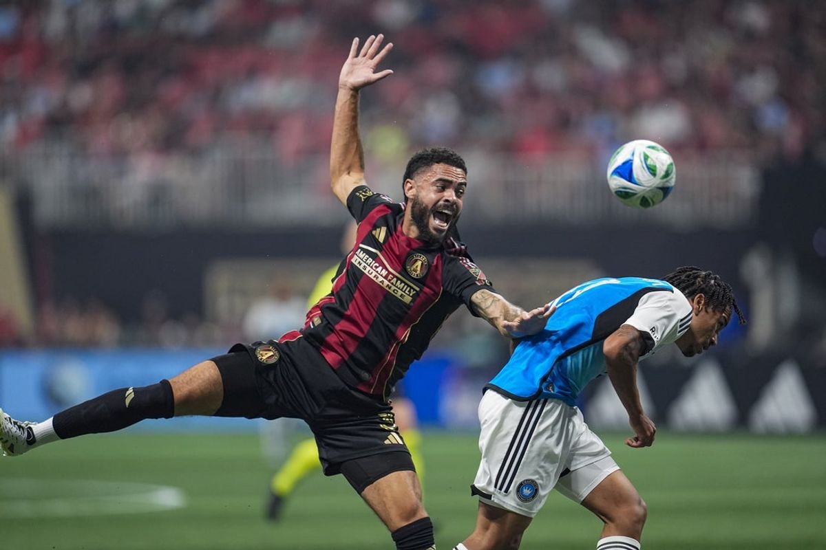 Jul 19, 2025; Atlanta, Georgia, USA; Atlanta United defender Derrick Williams (3) plays the ball away from Charlotte FC forward Idan Toklomati (17) during the first half at Mercedes-Benz Stadium. Mandatory Credit: Dale Zanine-Imagn Images
