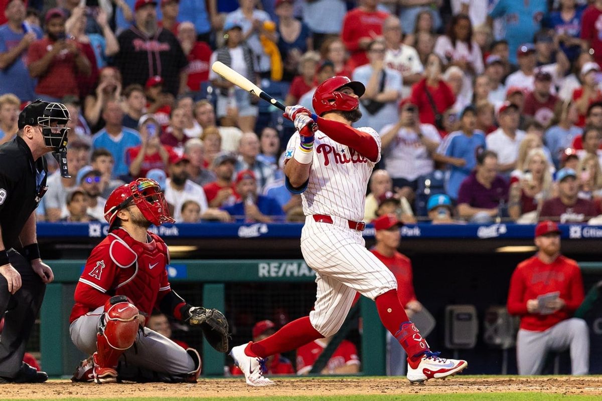 Jul 19, 2025; Philadelphia, Pennsylvania, USA; Philadelphia Phillies outfielder Kyle Schwarber (12) hits a grand slam home run during the sixth inning against the Los Angeles Angels at Citizens Bank Park. Mandatory Credit: Bill Streicher-Imagn Images