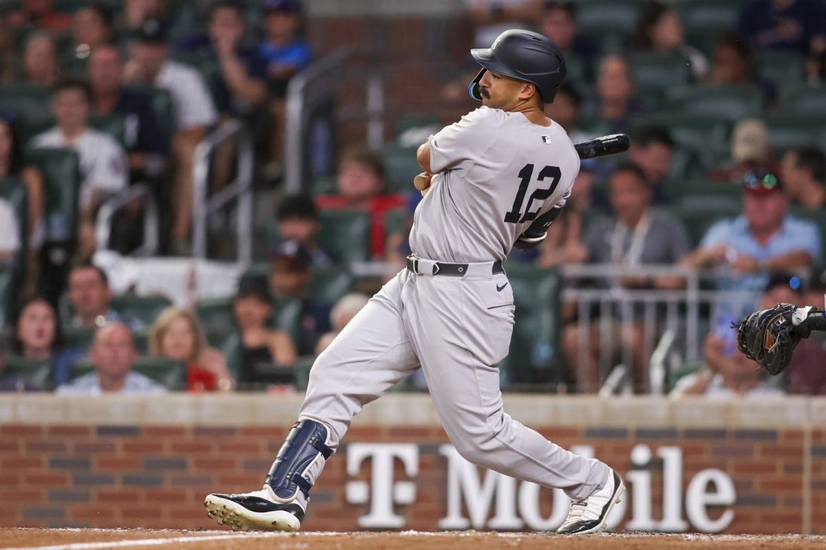 Jul 19, 2025; Atlanta, Georgia, USA; New York Yankees center fielder Trent Grisham (12) drives in a run on a fielder’s choice against the Atlanta Braves in the sixth inning at Truist Park. Mandatory Credit: Brett Davis-Imagn Images