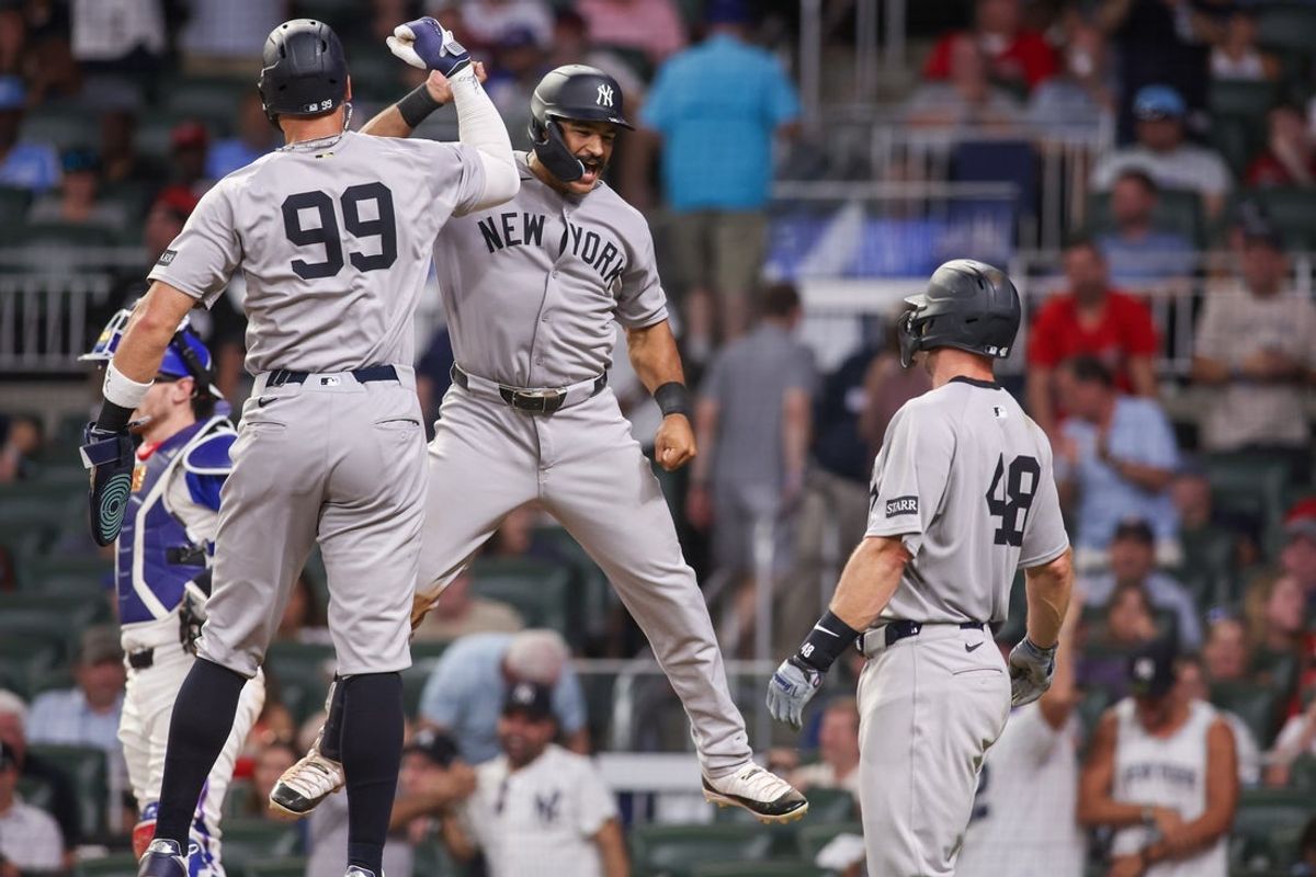 Jul 19, 2025; Atlanta, Georgia, USA; New York Yankees center fielder Trent Grisham (12) celebrates with right fielder Aaron Judge (99) after a grand slam against the Atlanta Braves in the ninth inning at Truist Park. Mandatory Credit: Brett Davis-Imagn Images