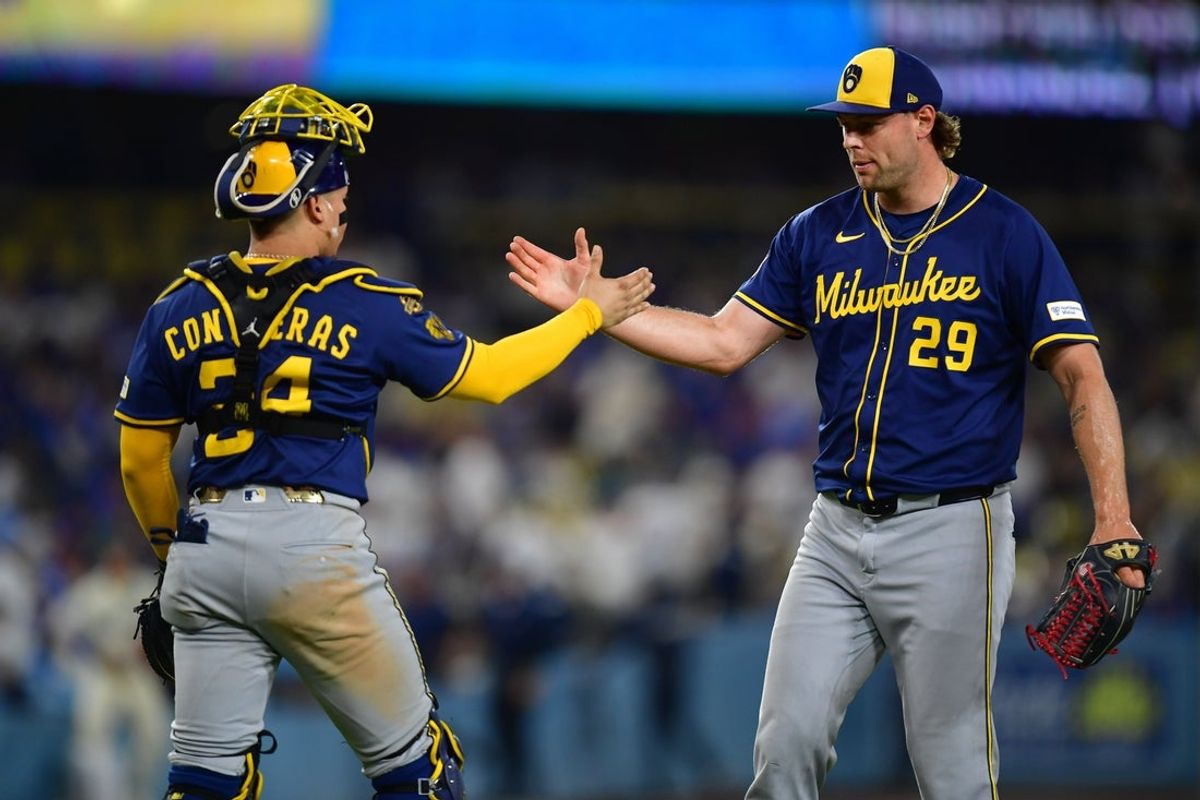 Jul 19, 2025; Los Angeles, California, USA; Milwaukee Brewers pitcher Trevor Megill (29) and catcher William Contreras (24) celebrate the victory against the Los Angeles Dodgers at Dodger Stadium. Mandatory Credit: Gary A. Vasquez-Imagn Images