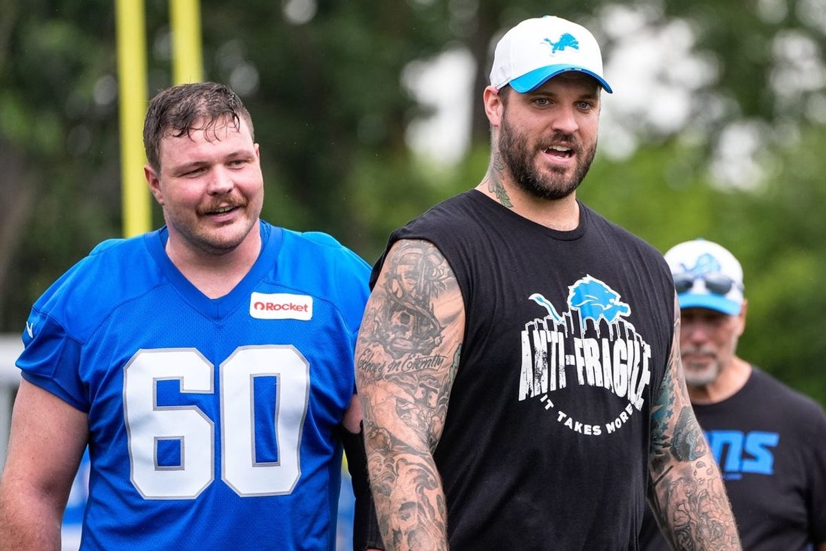Detroit Lions guard Graham Glasgow (60), left, talks to offensive tackle Taylor Decker (68) after practice during training camp at Meijer Performance Center in Allen Park on Sunday, July 20, 2025.