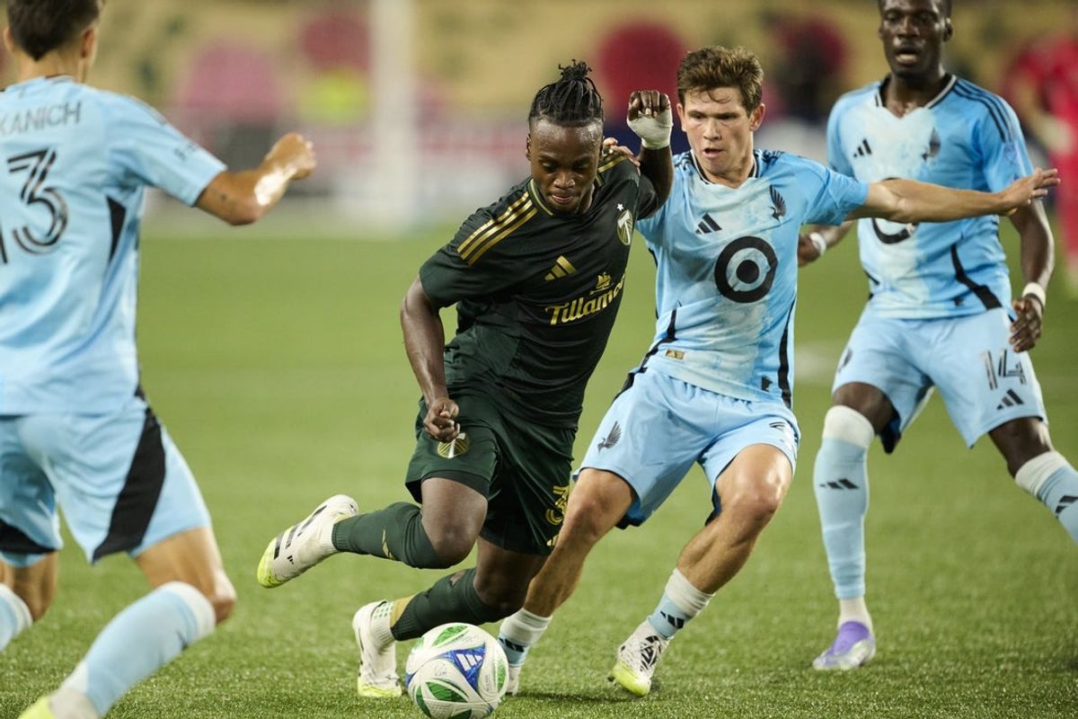 Jul 19, 2025; Portland, Oregon, USA; Portland Timbers midfielder Santiago Moreno (30) weaves past Minnesota United midfielder Will Trapp (20) during the second half at Providence Park. Mandatory Credit: Troy Wayrynen-Imagn Images