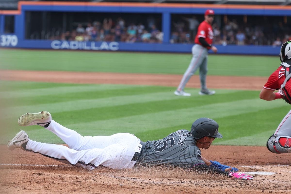 Jul 20, 2025; New York City, New York, USA; New York Mets center fielder Tyrone Taylor (15) scores a run during the third inning against the Cincinnati Reds at Citi Field. Mandatory Credit: Vincent Carchietta-Imagn Images