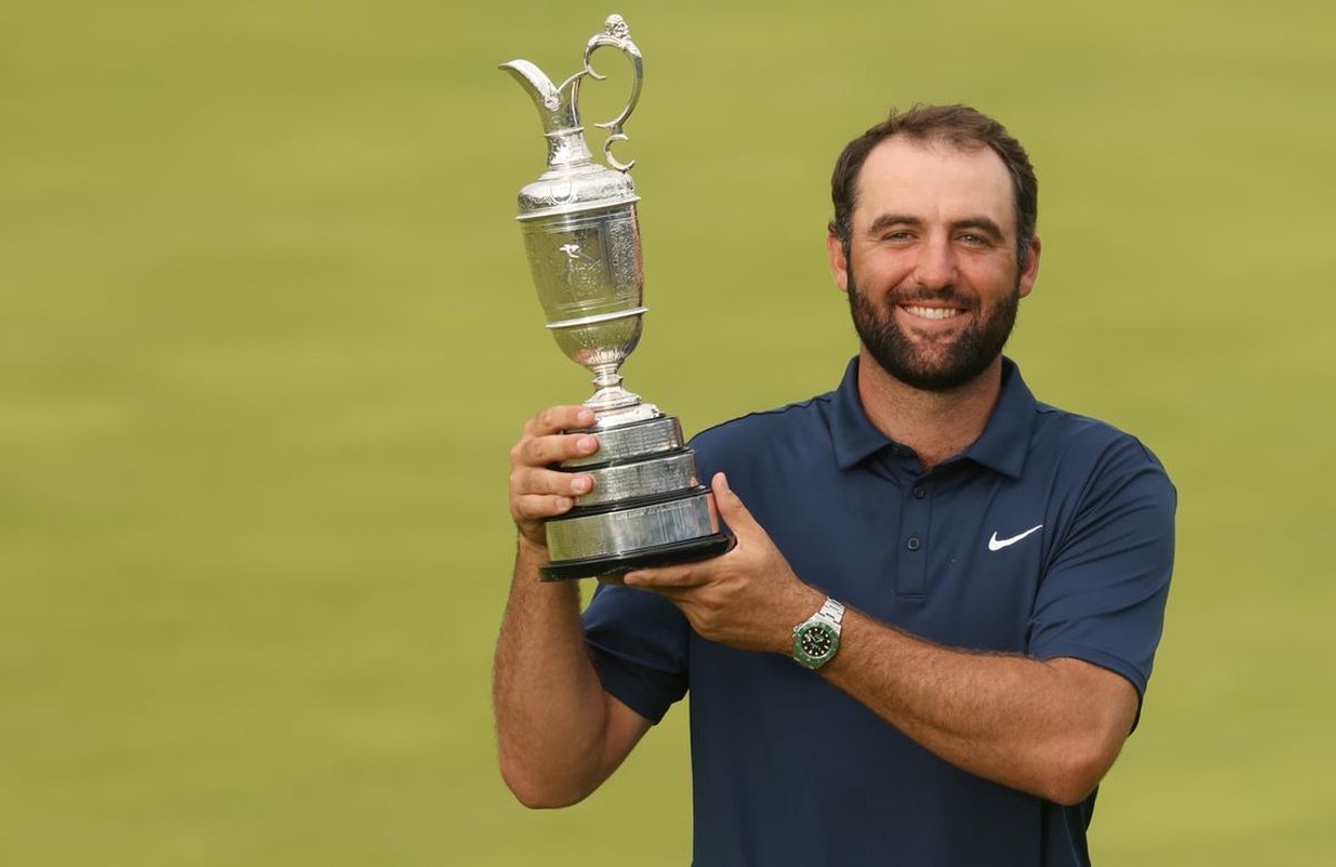 Jul 20, 2025; Portrush, IRL;  Scottie Scheffler celebrates with the Claret Jug after winning the 153rd Open Championship golf tournament at Royal Portrush. Mandatory Credit: Mike Frey-Imagn Images