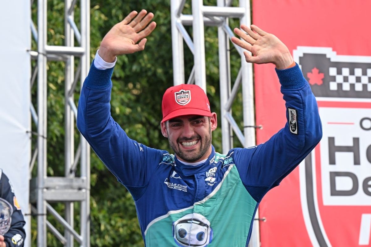 Jul 20, 2025; Toronto, Ontario, CAN;  Indycar driver Rinus Veekay (18) waves to fans as he celebrates a second place finish during the Ontario Honda Dealers Indy at Streets of Toronto. Mandatory Credit: Dan Hamilton-Imagn Images