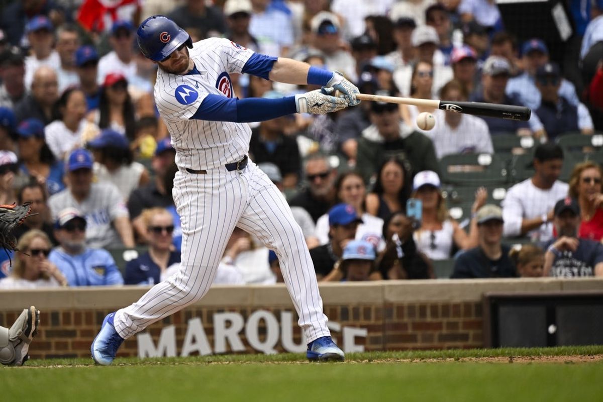 Jul 20, 2025; Chicago, Illinois, USA;  Chicago Cubs outfielder Ian Happ (8) hits an RBI single against the Boston Red Sox during the second inning at Wrigley Field. Mandatory Credit: Matt Marton-Imagn Images