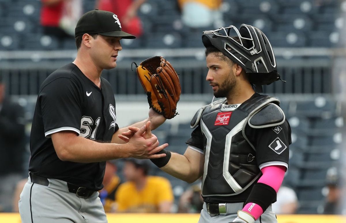 Jul 20, 2025; Pittsburgh, Pennsylvania, USA;  Chicago White Sox relief pitcher Mike Vasil (61) and catcher Edgar Quero (7) shake hands after defeating the Pittsburgh Pirates at PNC Park. Mandatory Credit: Charles LeClaire-Imagn Images