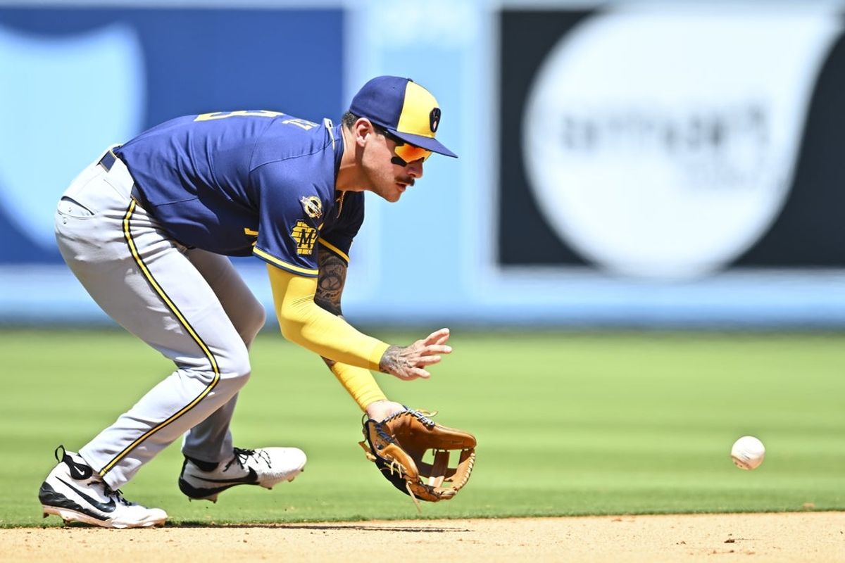 Jul 20, 2025; Los Angeles, California, USA; Milwaukee Brewers shortstop Joey Ortiz (3) fields a ball against the Los Angeles Dodgers during the fifth inning at Dodger Stadium. Mandatory Credit: Jonathan Hui-Imagn Images