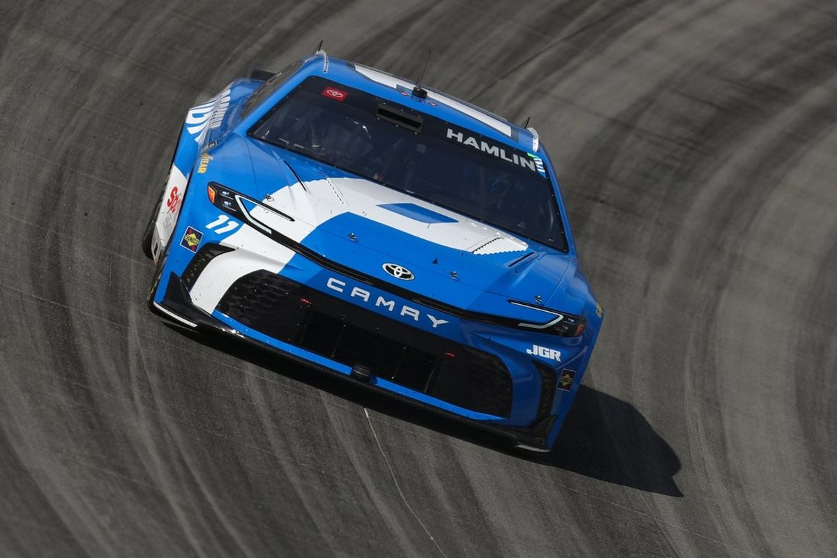 Jul 20, 2025; Dover, Delaware, USA; NASCAR Cup Series driver Denny Hamlin (11) races during the Autotrader EchoPark Automotive 400 at Dover Motor Speedway. Mandatory Credit: Matthew O'Haren-Imagn Images