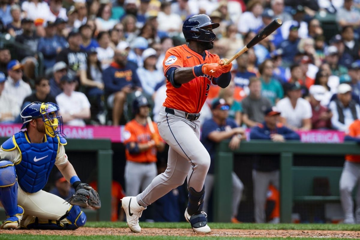 Jul 20, 2025; Seattle, Washington, USA; Houston Astros center fielder Taylor Trammell (26) hits a two-run double against the Seattle Mariners during the seventh inning at T-Mobile Park. Mandatory Credit: Joe Nicholson-Imagn Images