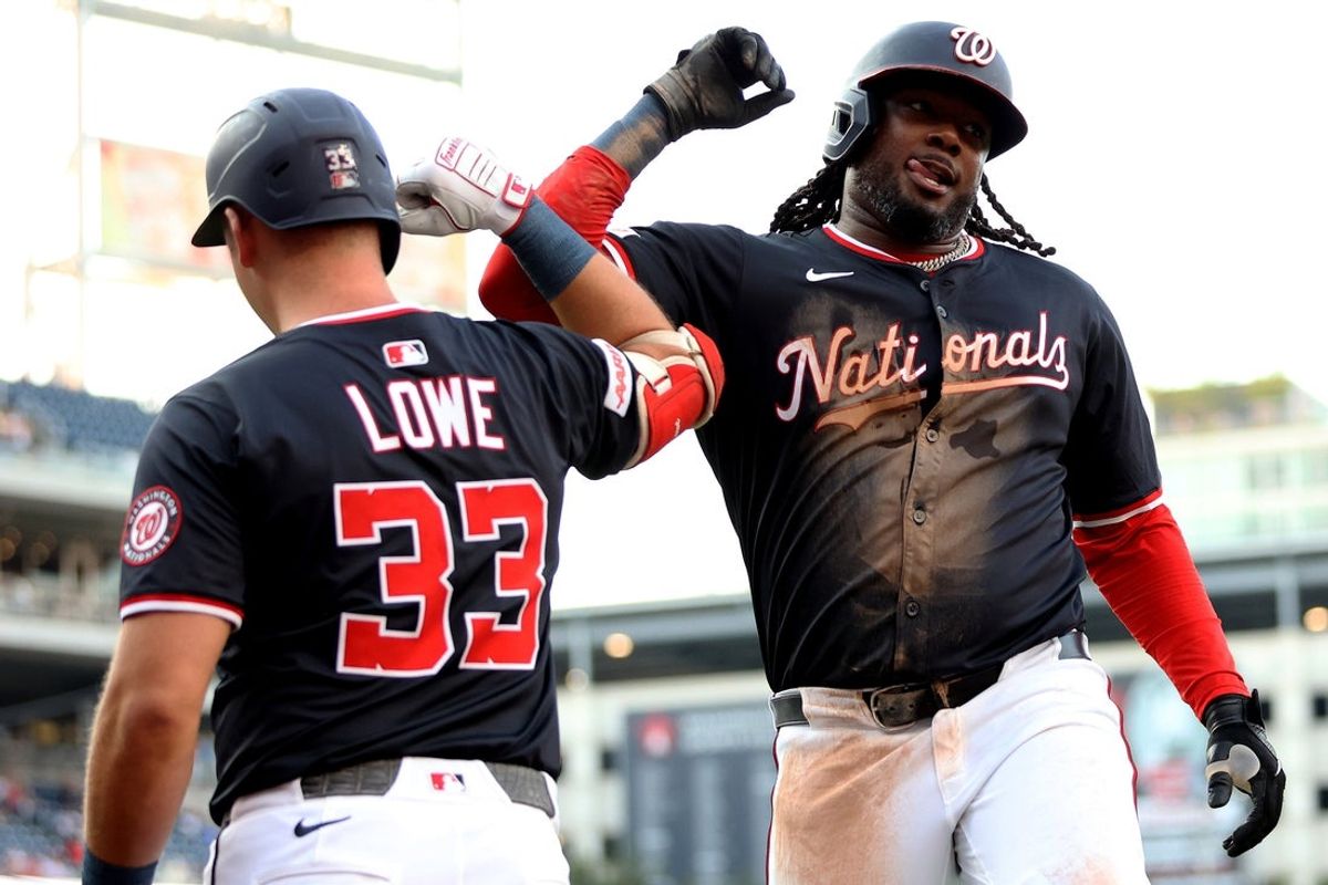 Jul 21, 2025; Washington, District of Columbia, USA; Washington Nationals first baseman Josh Bell (19) celebrates with Washington Nationals first baseman Nathaniel Lowe (33) after scoring a run during the third inning against the Cincinnati Reds at Nationals Park. Mandatory Credit: Daniel Kucin Jr.-Imagn Images