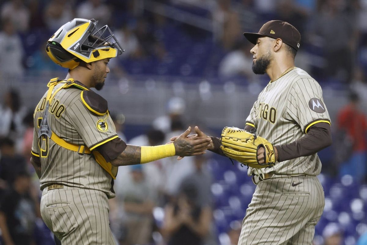 Jul 21, 2025; Miami, Florida, USA;  San Diego Padres catcher Martin Maldonado (15) and relief pitcher Robert Suarez (75) celebrate their win against the Miami Marlins following the game at loanDepot Park. Mandatory Credit: Rhona Wise-Imagn Images