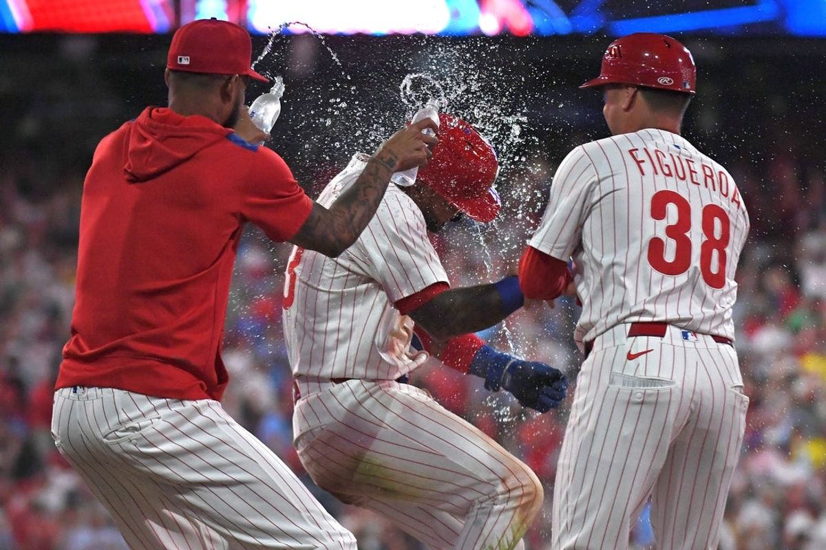 Jul 21, 2025; Philadelphia, Pennsylvania, USA; Philadelphia Phillies second base Edmundo Sosa (33) celebrates a walk-off win on catcher's interference with teammates during the tenth inning against the Boston Red Sox at Citizens Bank Park. Mandatory Credit: Eric Hartline-Imagn Images