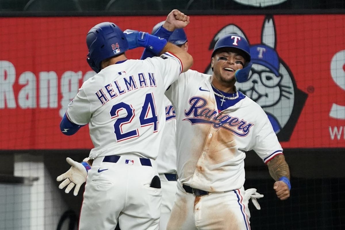 July 21, 2025; Arlington, Texas, USA; Texas Rangers outfielder Micheal Helman (24) elbow bumps Texas Rangers designated hitter Cody Freeman (39) after hitting a three-run home run at Globe Life Field. Helman collected his first MLB home run and Freeman his first MLB hit both in the fifth inning against the Athletics. Mandatory Credit: Raymond Carlin III-Imagn Images