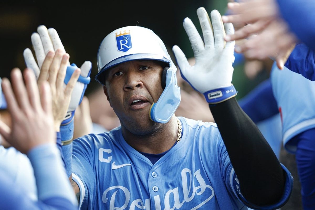 Jul 21, 2025; Chicago, Illinois, USA; Kansas City Royals catcher Salvador Perez (13) celebrates with teammates in the dugout after hitting a two-run home run against the Chicago Cubs during the fourth inning at Wrigley Field. Mandatory Credit: Kamil Krzaczynski-Imagn Images