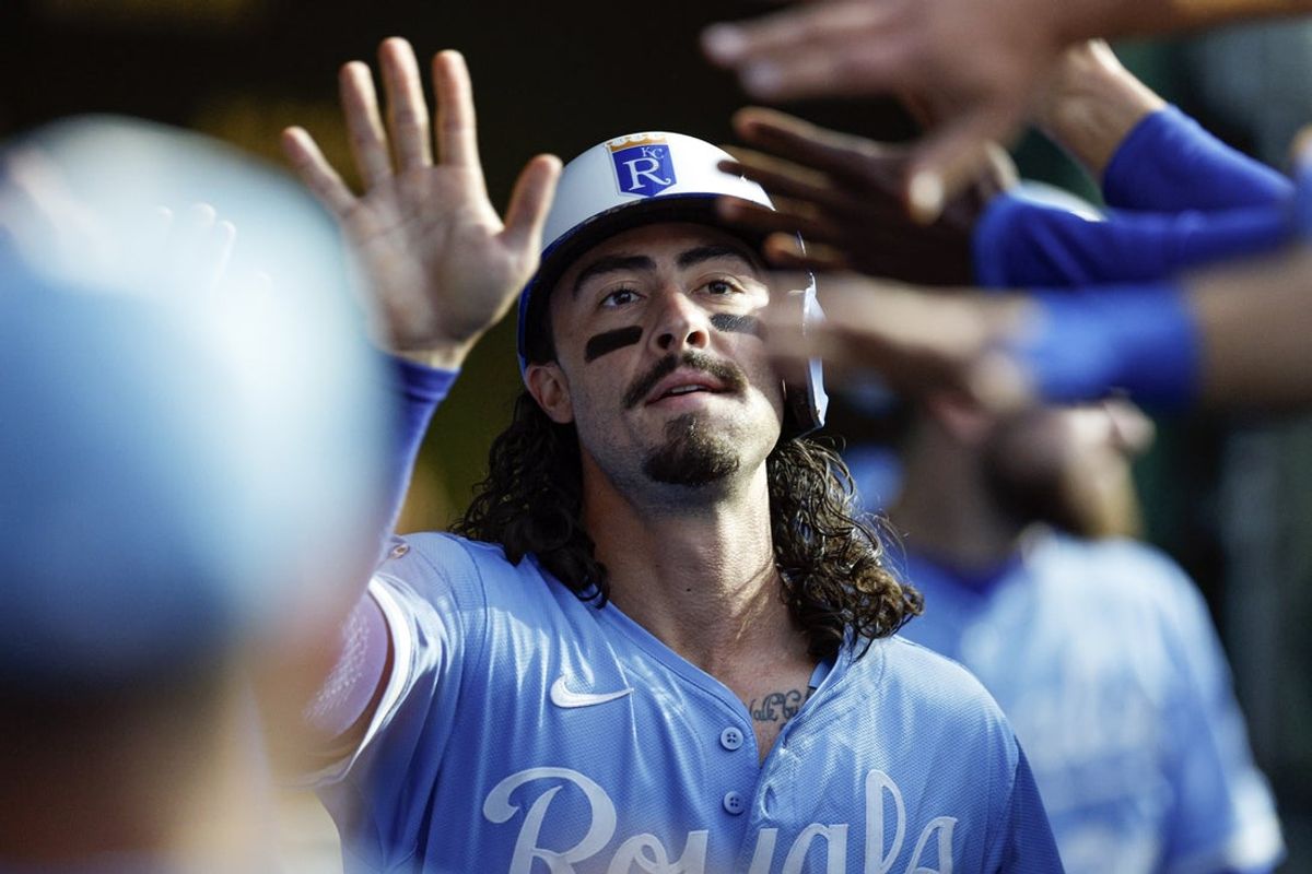 Jul 21, 2025; Chicago, Illinois, USA; Kansas City Royals designated hitter Jonathan India (6) celebrates in the dugout with teammates after scoring against the Chicago Cubs during the fifth at Wrigley Field. Mandatory Credit: Kamil Krzaczynski-Imagn Images